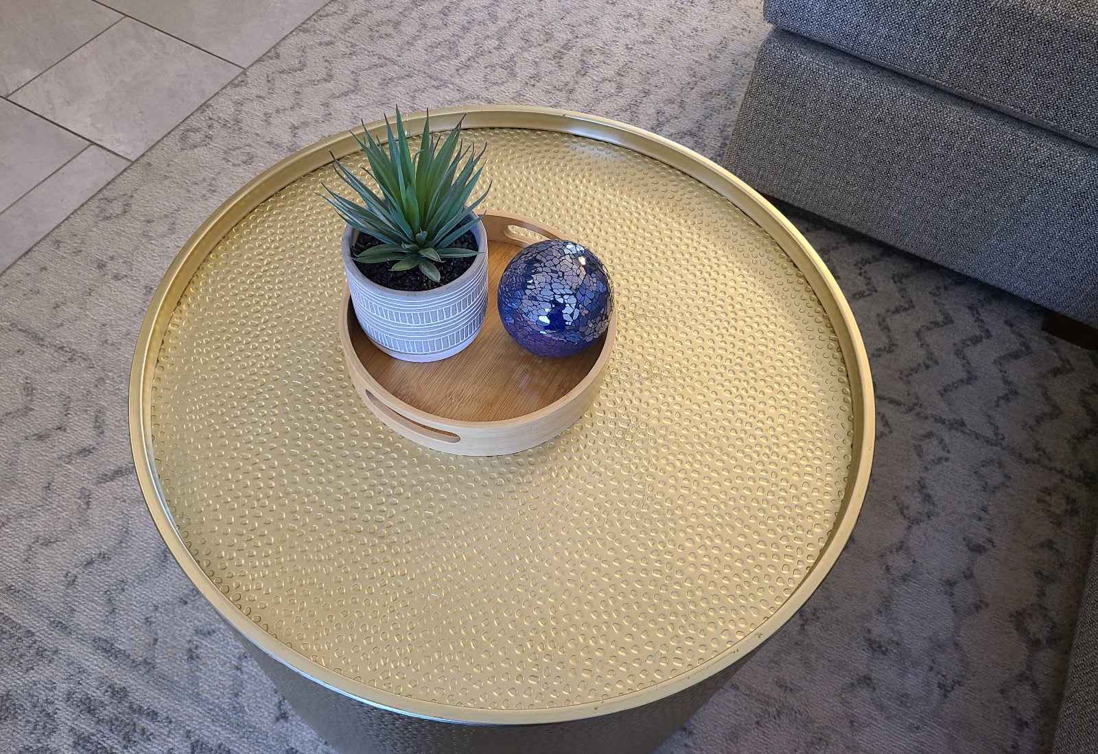Golden hour, all day long—this chic hammered-metal table brings glam vibes and a cozy touch to your lounging experience.