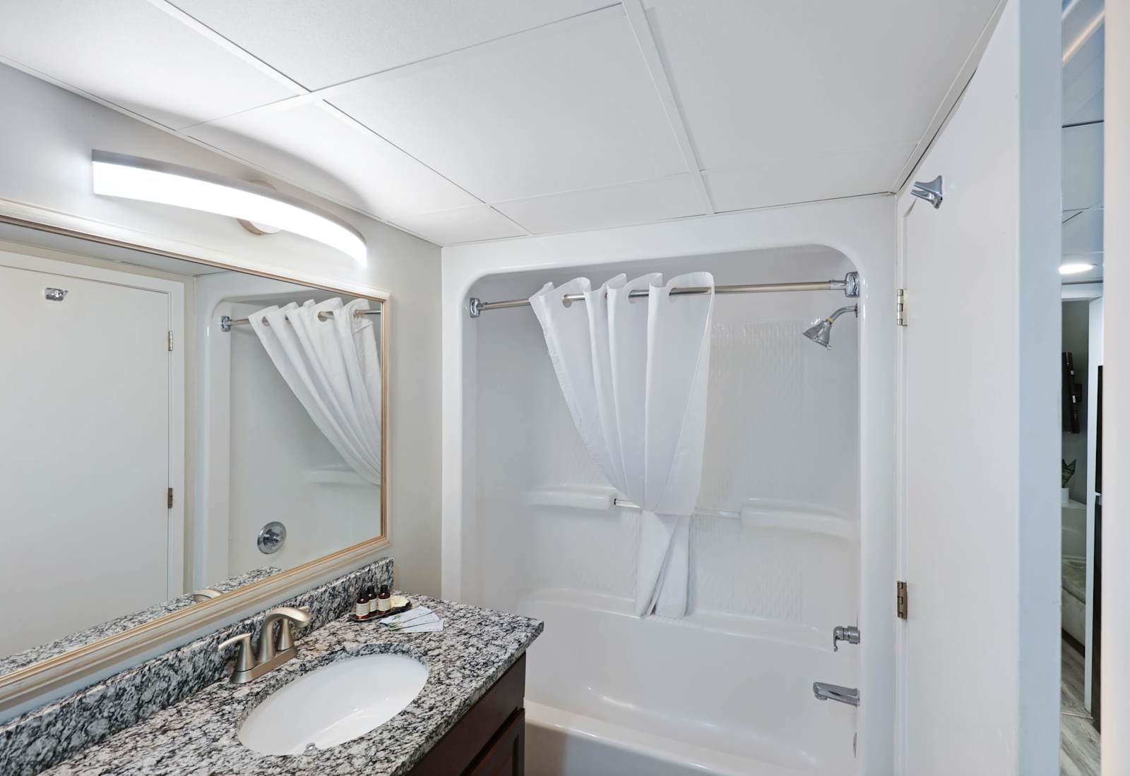 Freshen up in this sparkling clean bathroom featuring a sleek granite countertop, modern fixtures, and a full shower/tub combo. Stocked with essentials to ensure a relaxing and hassle-free stay!
