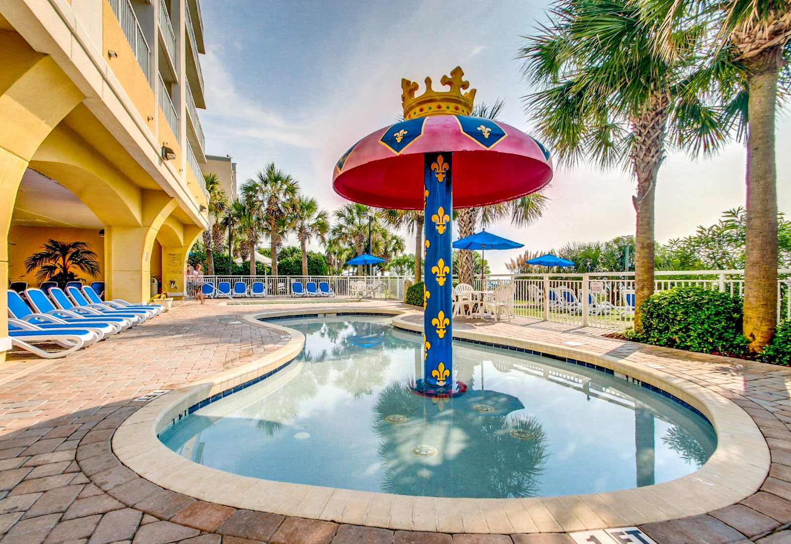 Make a splash in this fun, family-friendly pool area featuring a unique mushroom-shaped fountain and plenty of lounge chairs. Relax and soak up the sun while enjoying the beautiful surroundings. Your perfect vacation retreat awaits!