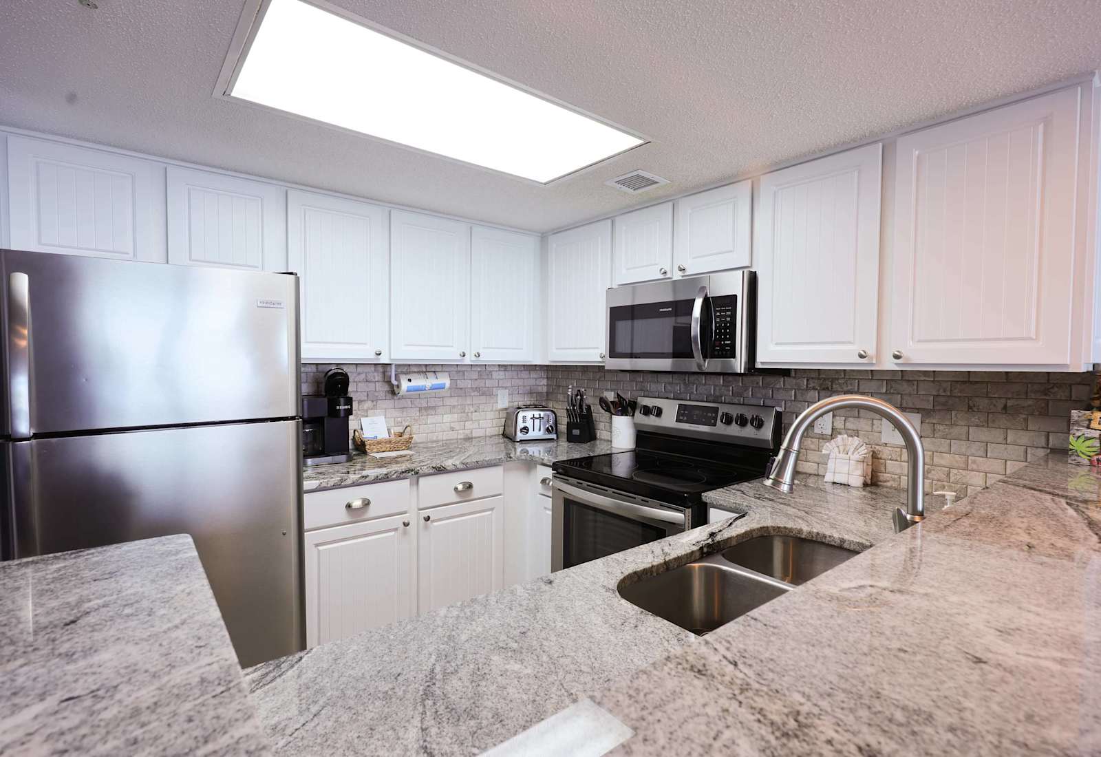 This fully equipped, modern kitchen features stainless steel appliances and ocean-view charm—perfect for whipping up a hearty breakfast before hitting the beach for the day!
