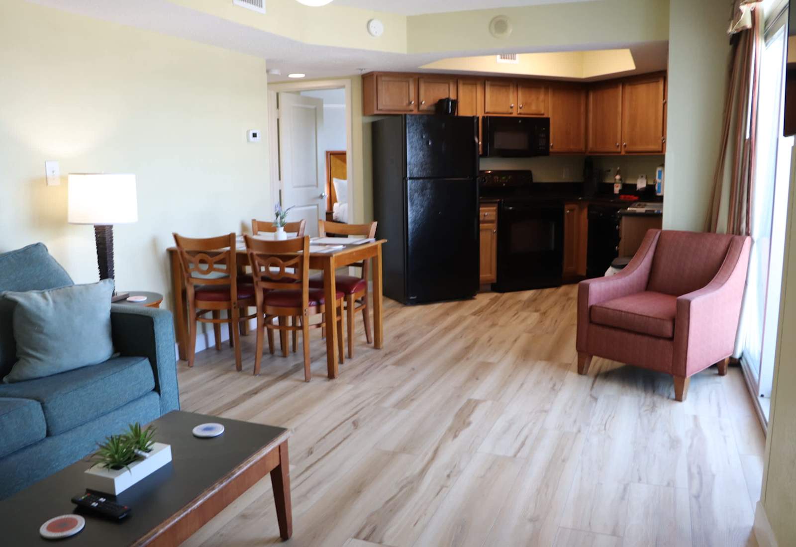Bright and inviting living space with an open layout, comfortable seating, dining area, and a fully equipped kitchen — perfect for relaxing after a day at the beach in Myrtle Beach.