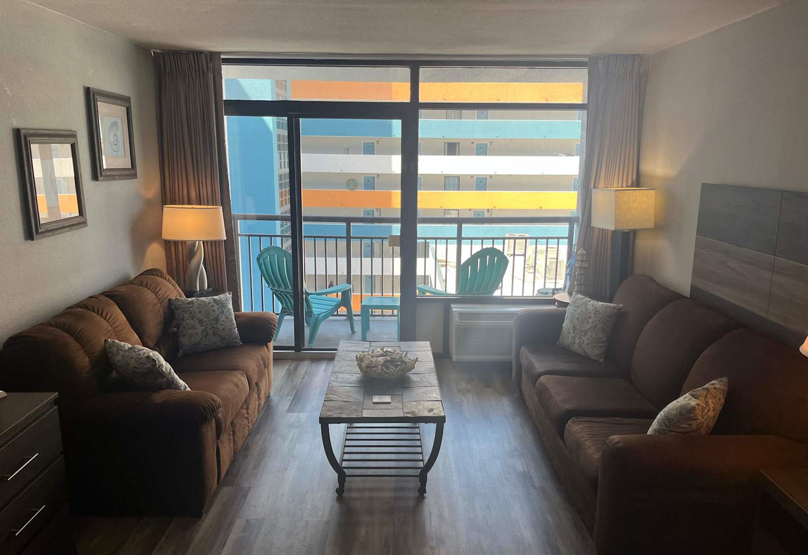 Spacious secondary living area featuring dual comfortable sofas and private balcony access