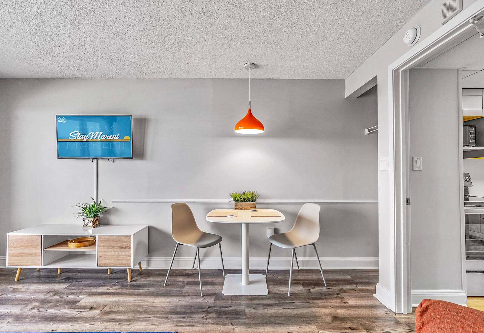 Bright and airy dining area with a table for two, perfect for enjoying meals with a view.
