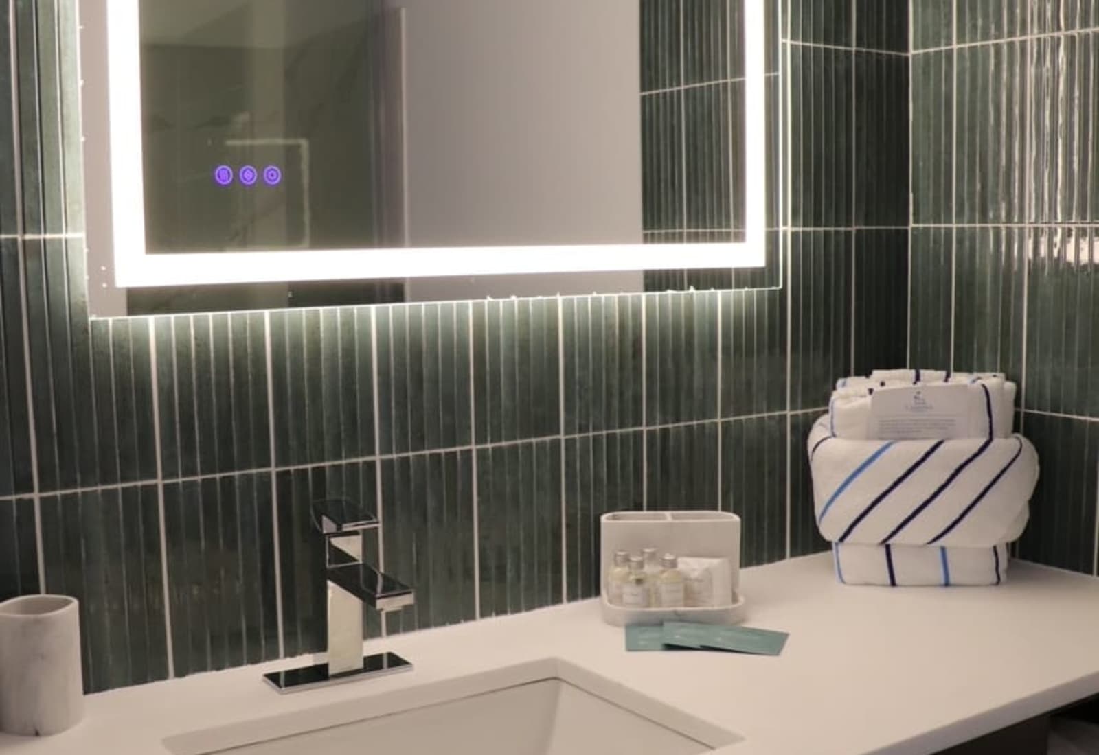 Refresh in style with a beautifully renovated bathroom featuring a spacious quartz vanity, LED backlit mirror, upscale finishes, plush towels, and premium complimentary toiletries.