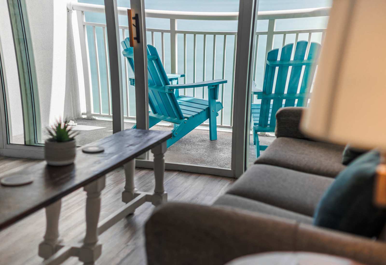 Relax in the cozy living area with direct balcony access and beautiful ocean views just steps away.