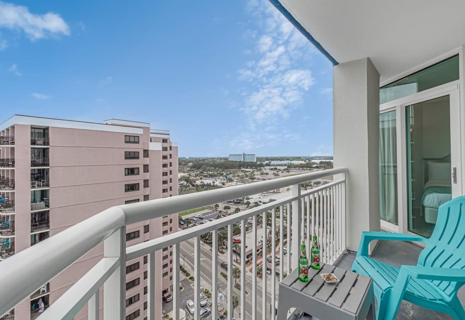 Oceanfront balcony with turquoise seating, wide water views, and a peaceful spot to unwind above the beach.