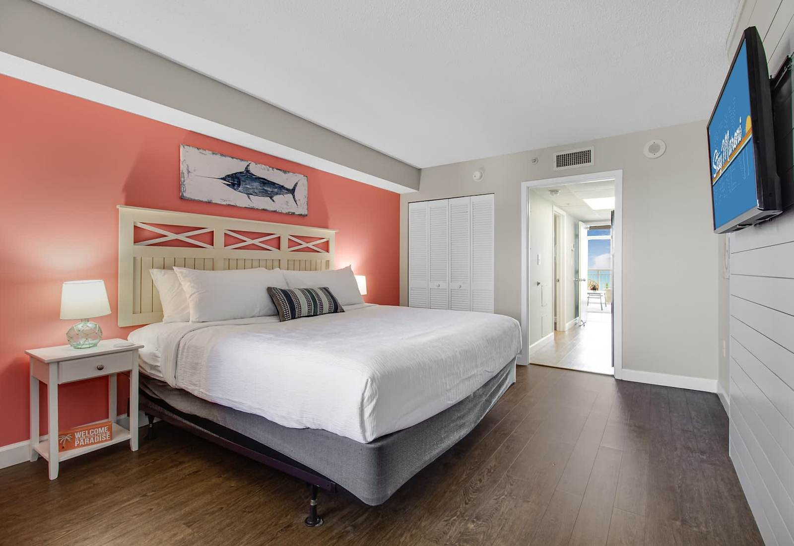 Wake up refreshed in this vibrant, beach-inspired bedroom! With a plush bed, bright decor, and modern conveniences like a flat-screen TV, this space combines comfort and style for the perfect seaside escape.