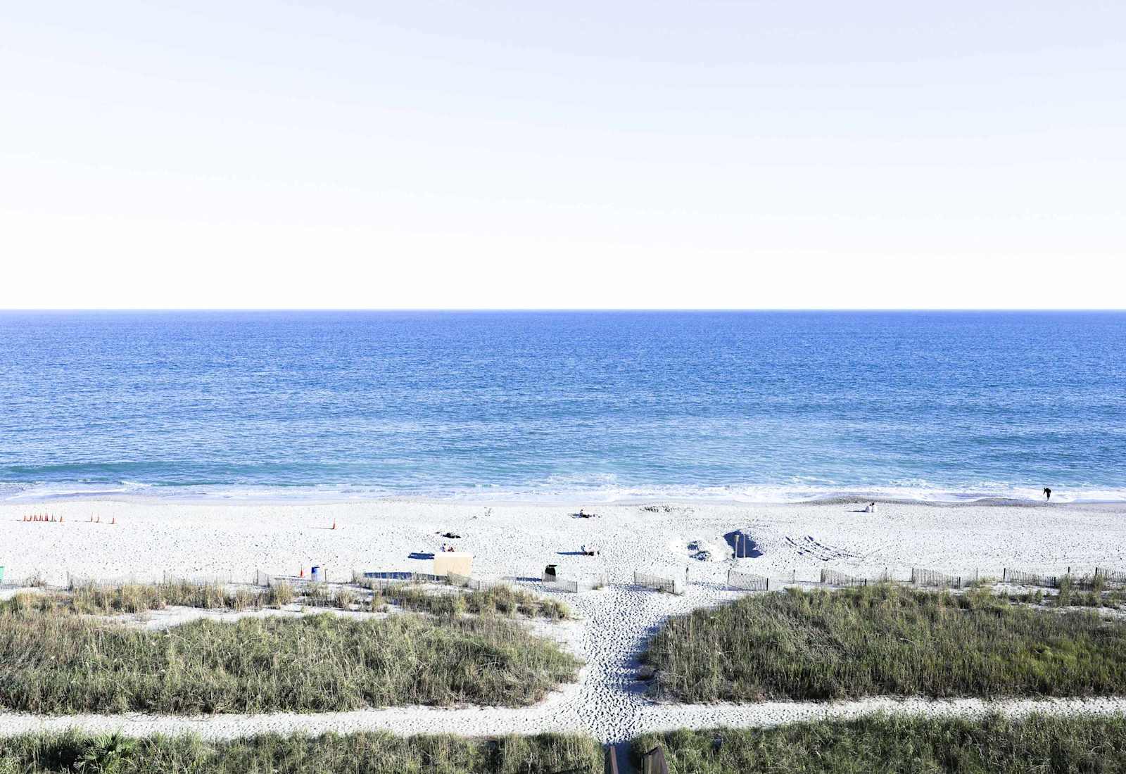Wake up to endless ocean views — just steps from the soft white sand and the calming sound of waves.