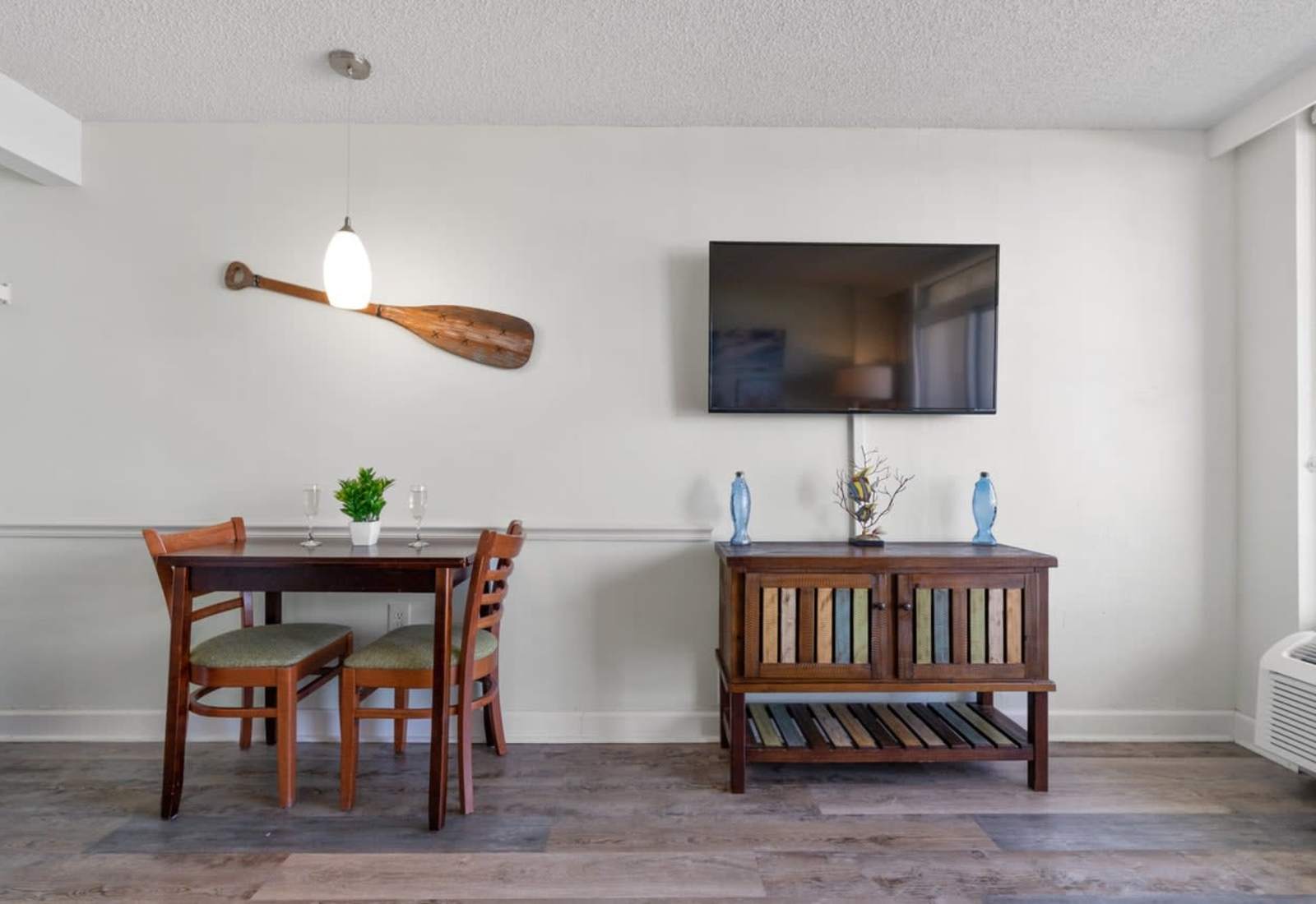 Enjoy meals or movie nights in this cozy dining and living area, featuring a coastal-inspired design, flat-screen TV, and charming beach décor that perfectly blends comfort with seaside charm.