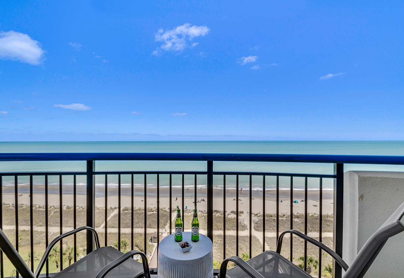 
Step out onto your private balcony and soak in panoramic ocean views. With comfortable seating and a side table perfect for snacks or drinks, this serene spot invites you to unwind and enjoy the gentle sea breeze and the calming sound of the waves.