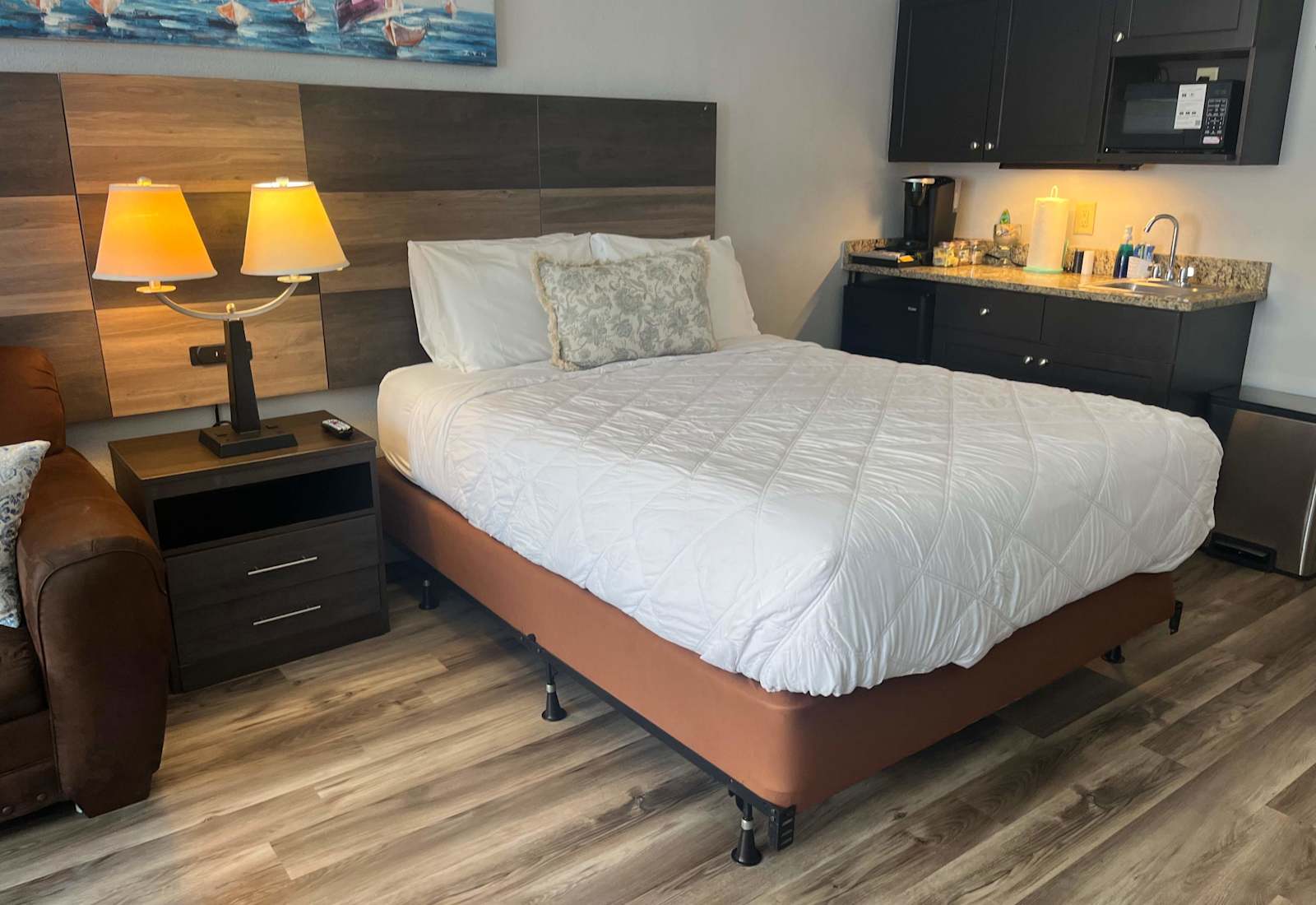 Comfortable secondary sleeping area featuring a plush bed alongside a convenient kitchenette station