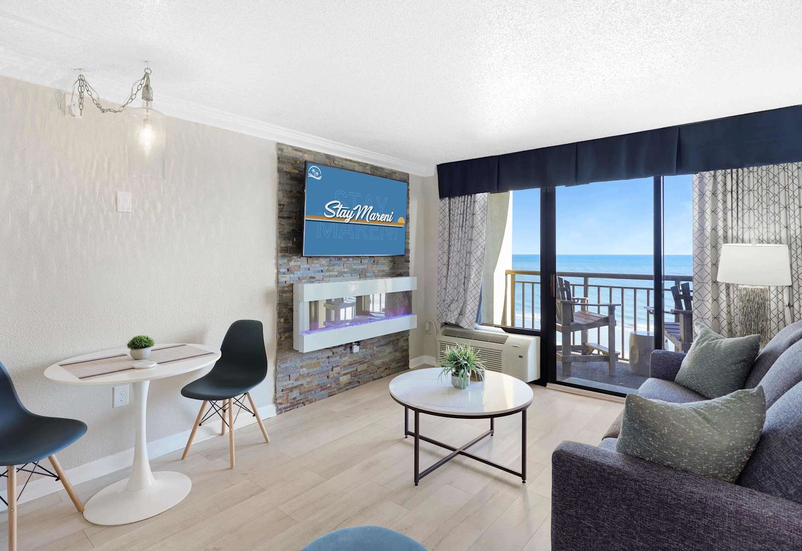 Enjoy ocean views right from your living room in this stylish beachfront condo, complete with a cozy fireplace, smart TV, and private balcony. The perfect space to relax after a day in the sun.