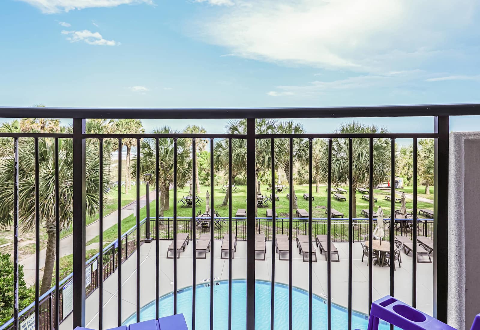 Sip your morning coffee with this view—lush palms, poolside vibes, and the beach path just steps away. Your private balcony is the front row seat to paradise. 