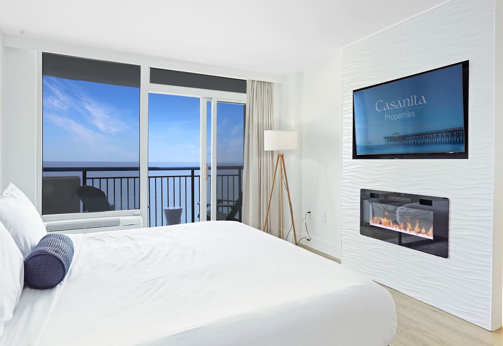 Spacious guest bedroom featuring a King-sized bed, plush linens, and a smart TV for winding down in comfort.
