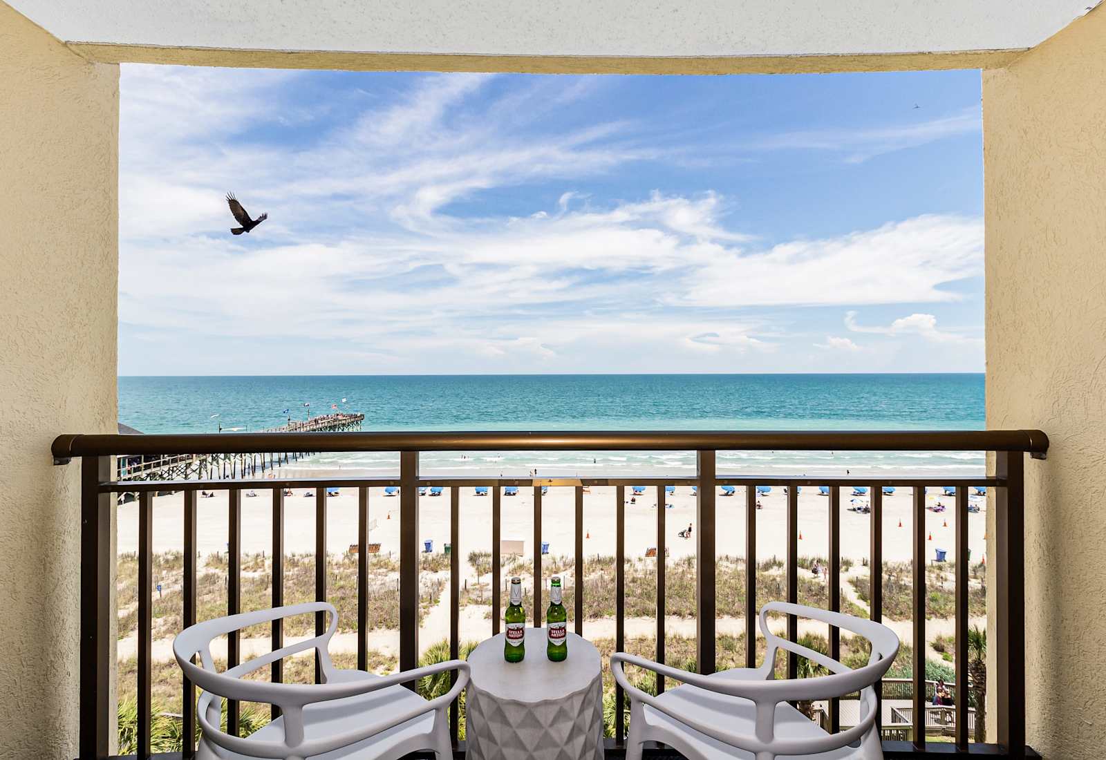 Enjoy stunning ocean views from your private balcony, complete with cozy seating to relax and take in the sights of the beach. Perfect for morning coffee or sunset evenings!