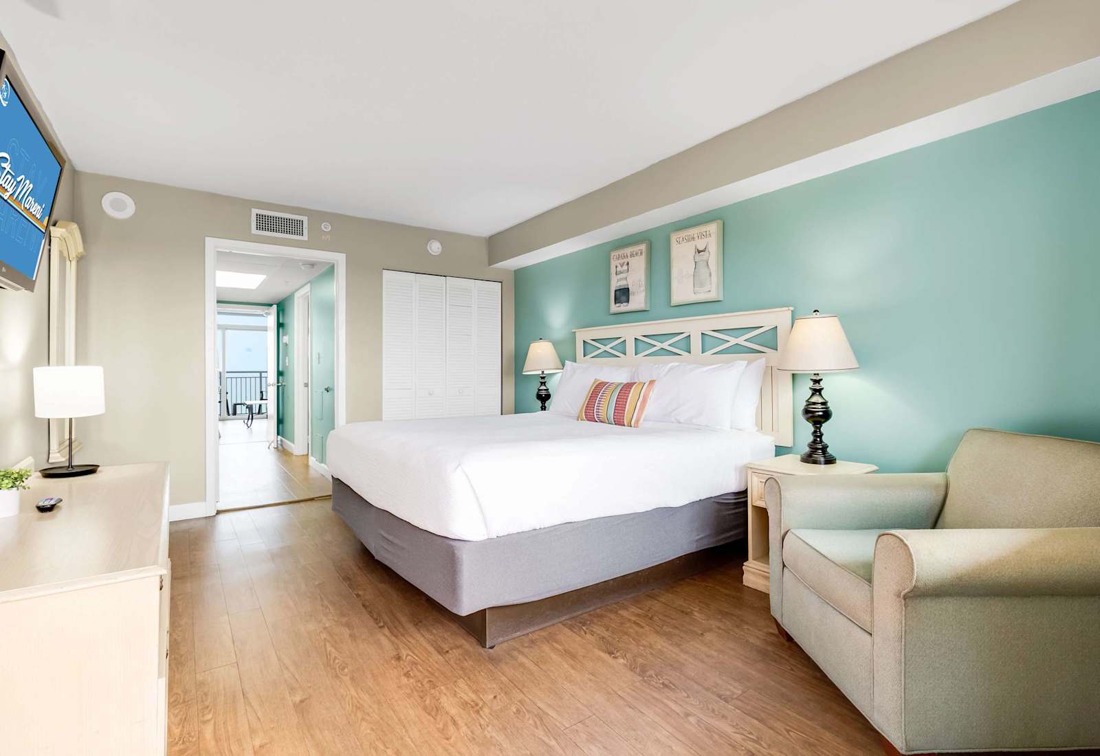 Relax in this bright and spacious bedroom featuring a plush king-sized bed, stylish coastal decor, and ample natural light. Perfect for unwinding after a day of beach adventures!