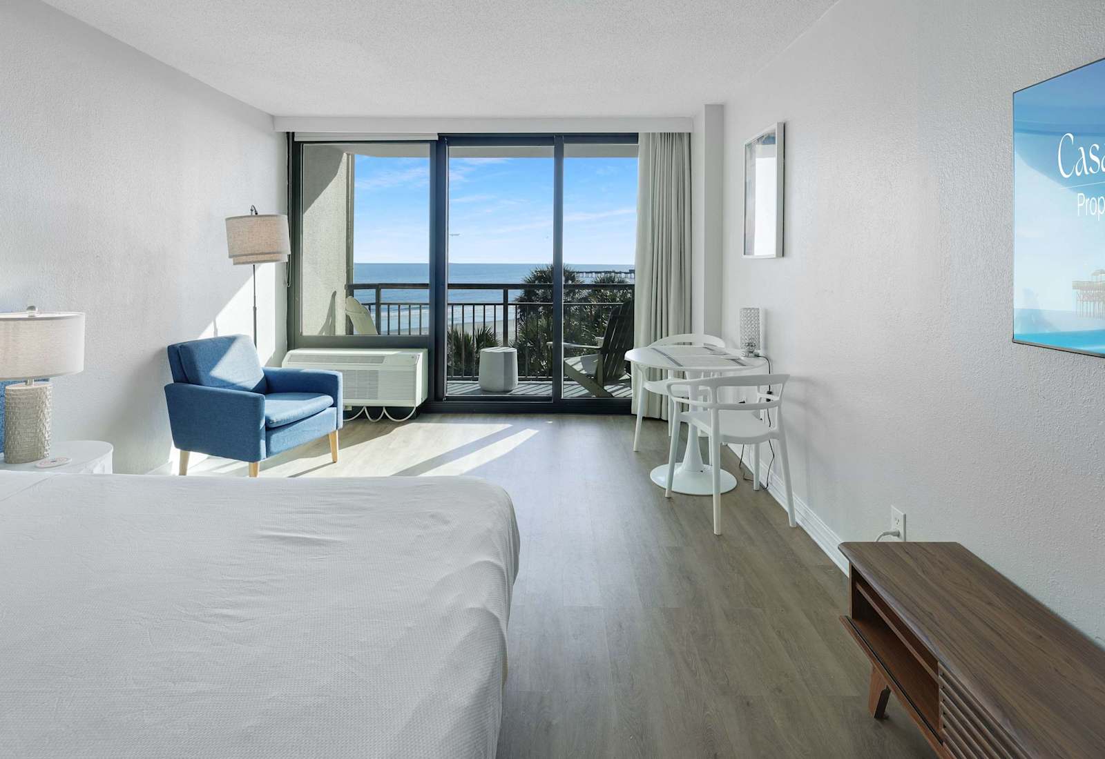 Bright ocean-view studio with a comfortable bed, cozy seating, dining space, and private balcony — a relaxing Myrtle Beach escape just steps from the water.