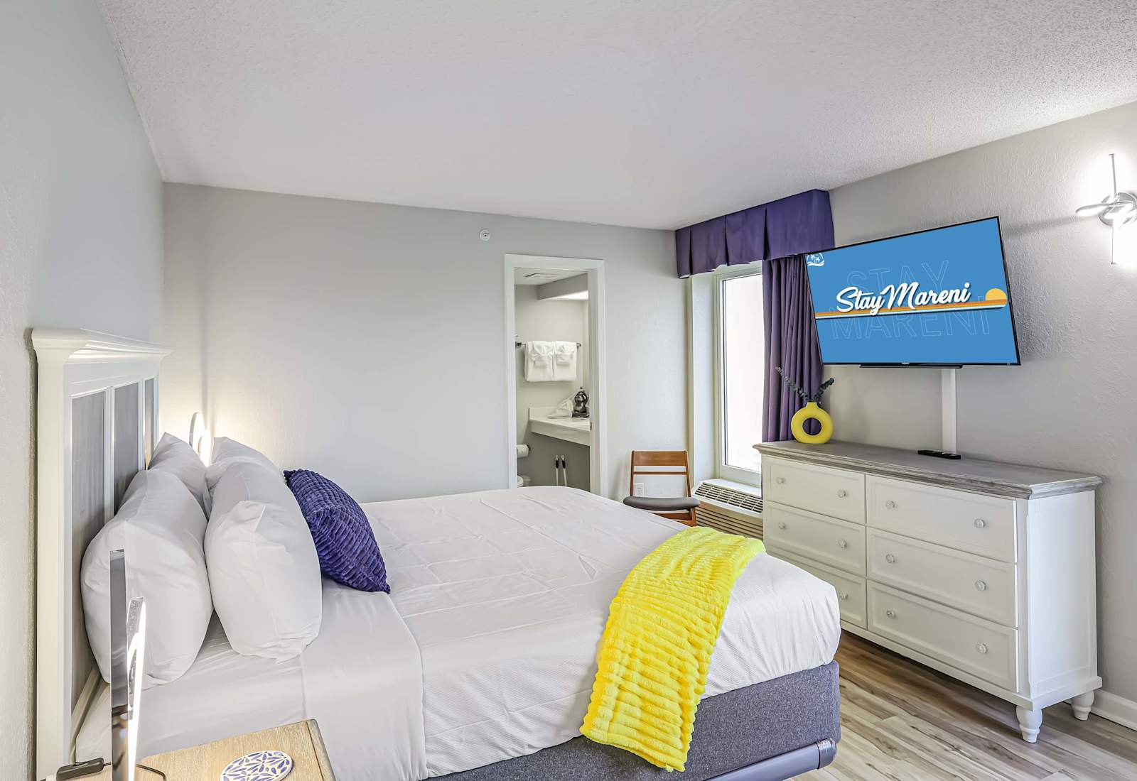 Wake up in style with cozy coastal vibes, pops of color, and your own private ensuite. Comfy king bed, flat-screen TV, and natural light make this the ultimate recharge zone after a day on the beach!