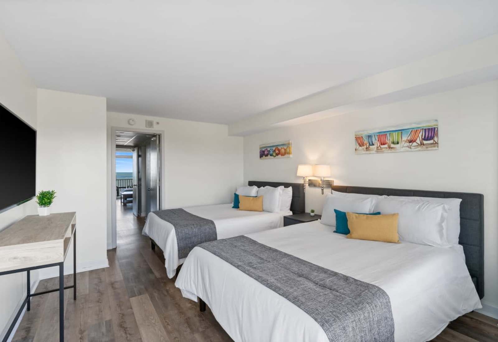 Wake up to waves and sunshine in this stylish double queen room—perfect for families or friends looking to soak up the ocean breeze and unwind in comfort with a view.