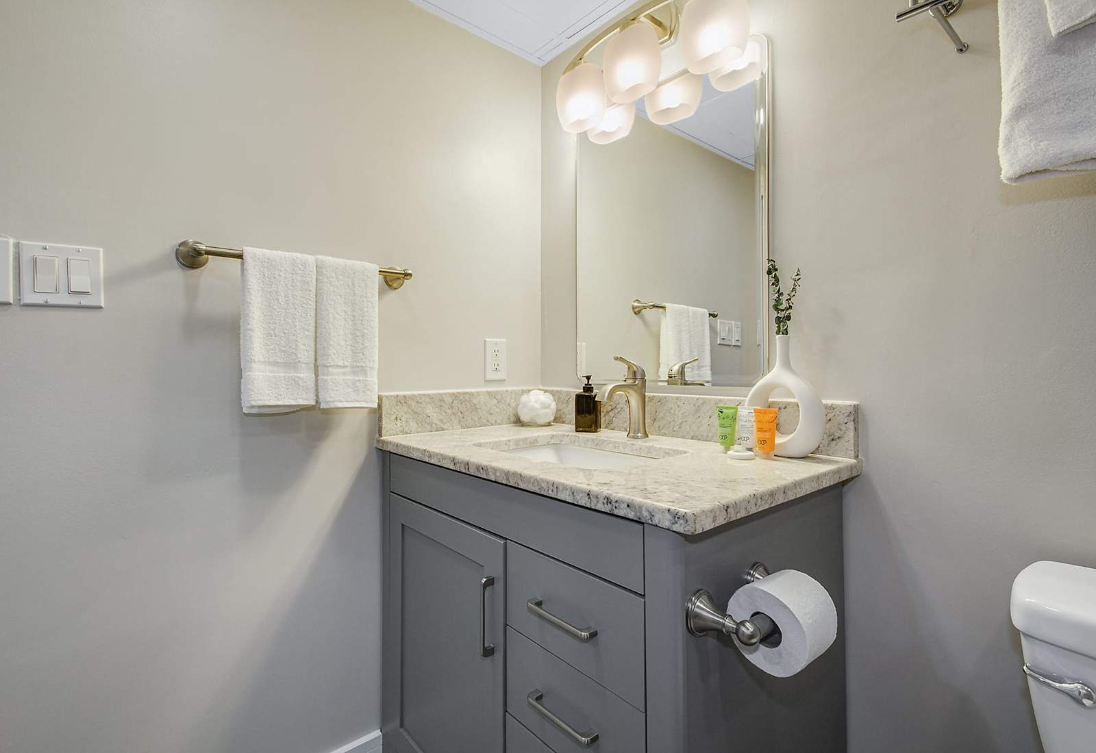 Relax and refresh in this contemporary bathroom with a stylish vanity and plenty of storage.