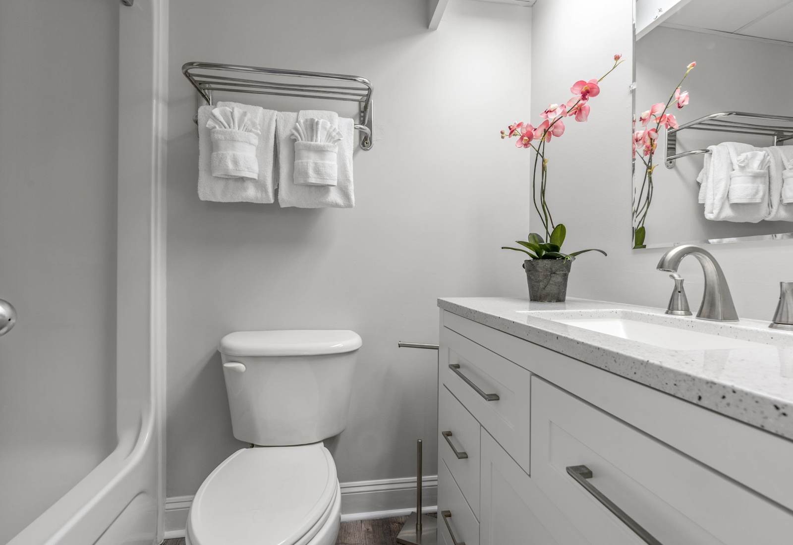 Relax and unwind in the clean and modern bathroom with a shower/tub combo and granite countertop vanity.

