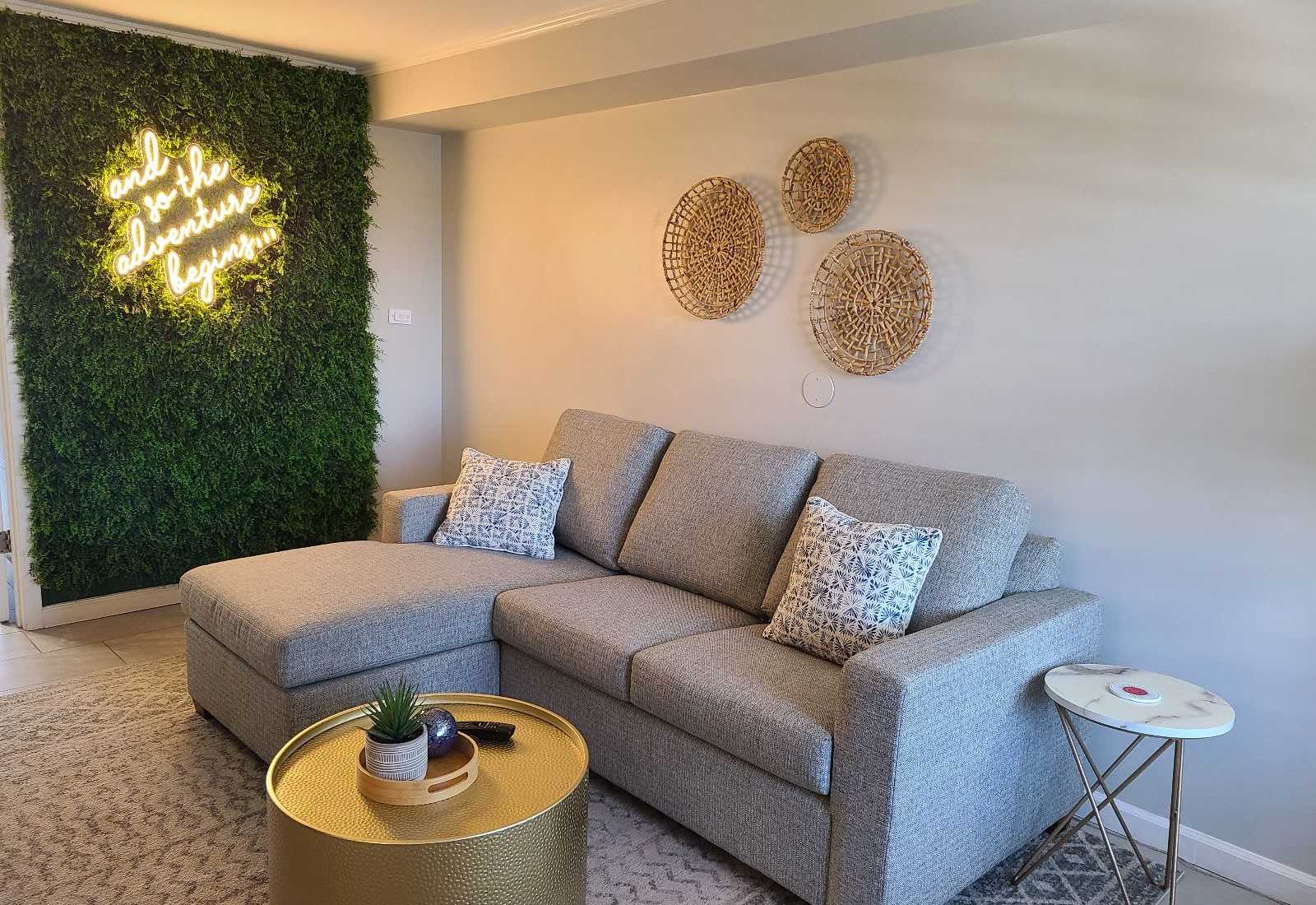 Cozy up on this plush sectional under a glowing neon sign that says it all—“and so the adventure begins.” The perfect Insta-worthy corner to kick off your beach escape! 
