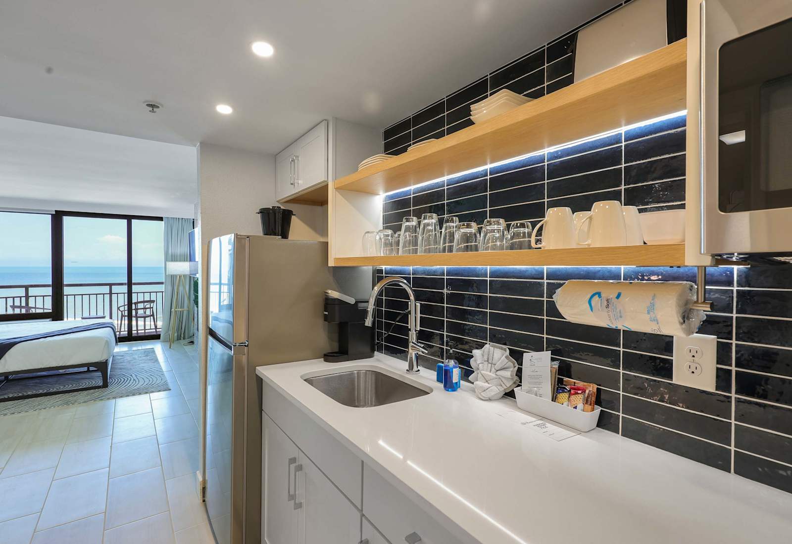 Enjoy the convenience of a full kitchen with everything you need to cook up your favorites. With ocean views just steps away, this space makes dining in as delightful as heading out. Perfect for extended stays or cozy beachside meals.