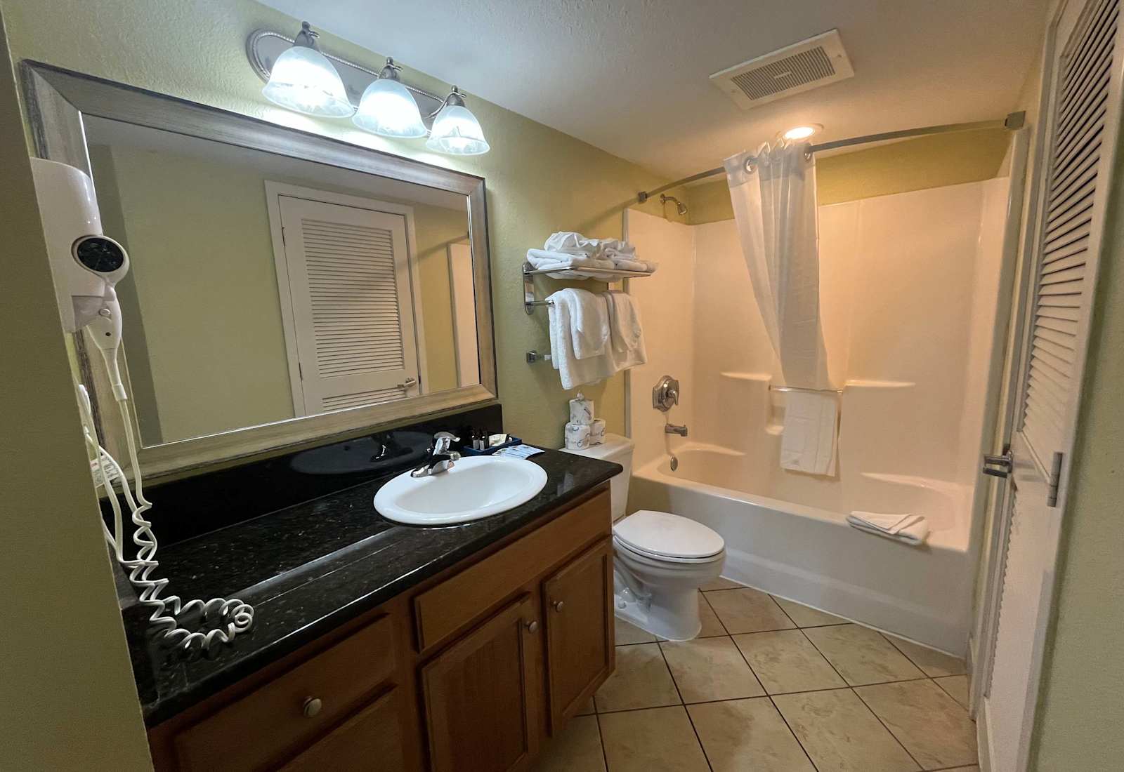 Relax in the tub or refresh at the spacious vanity, complete with soft towels and quality toiletries. Every detail is thoughtfully arranged to offer a soothing and comfortable experience.