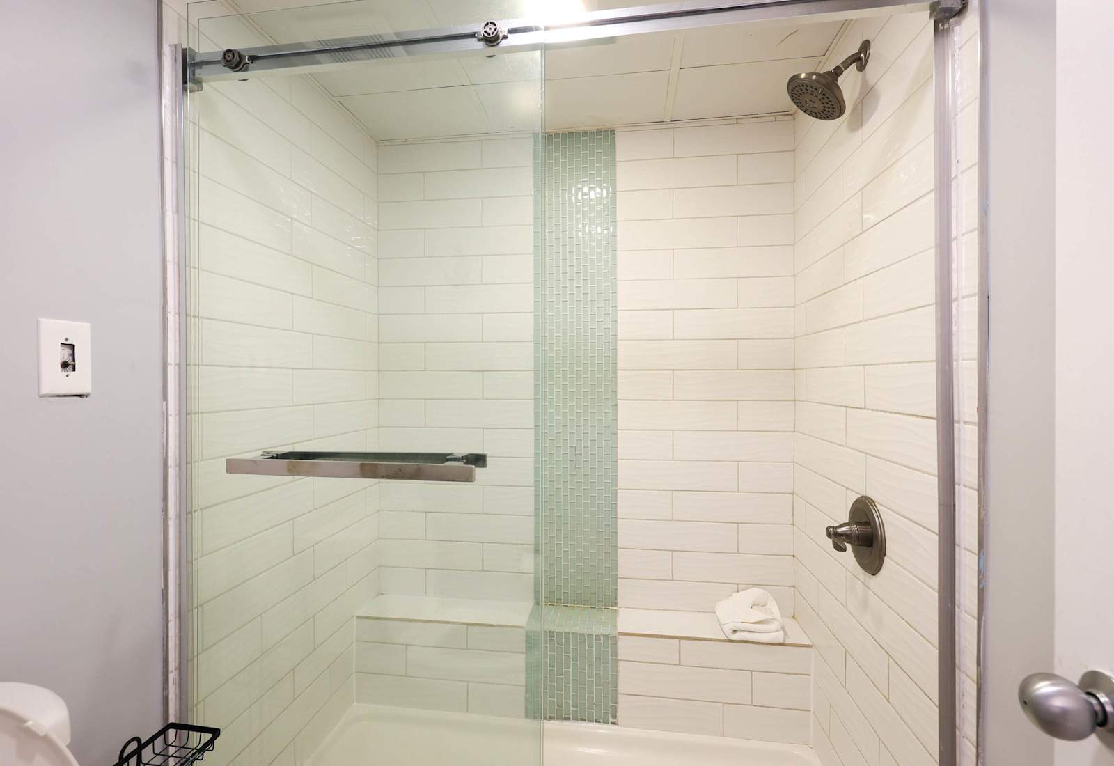 Refresh and unwind in this modern walk-in shower featuring sleek tile, a rainfall showerhead, and built-in bench. A spa-inspired touch to elevate your comfort during your Myrtle Beach stay!