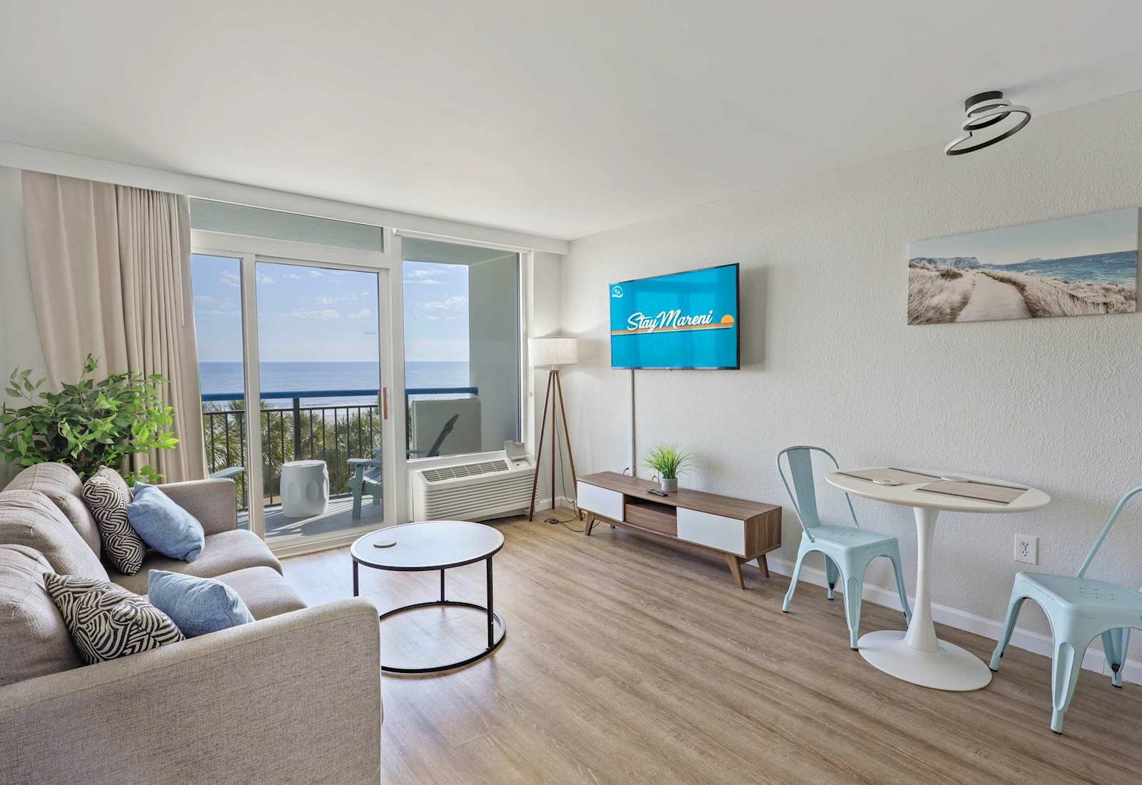 Charming dining nook with a modern table for two, perfectly positioned beside the living space and just steps from the balcony’s relaxing oceanfront views.