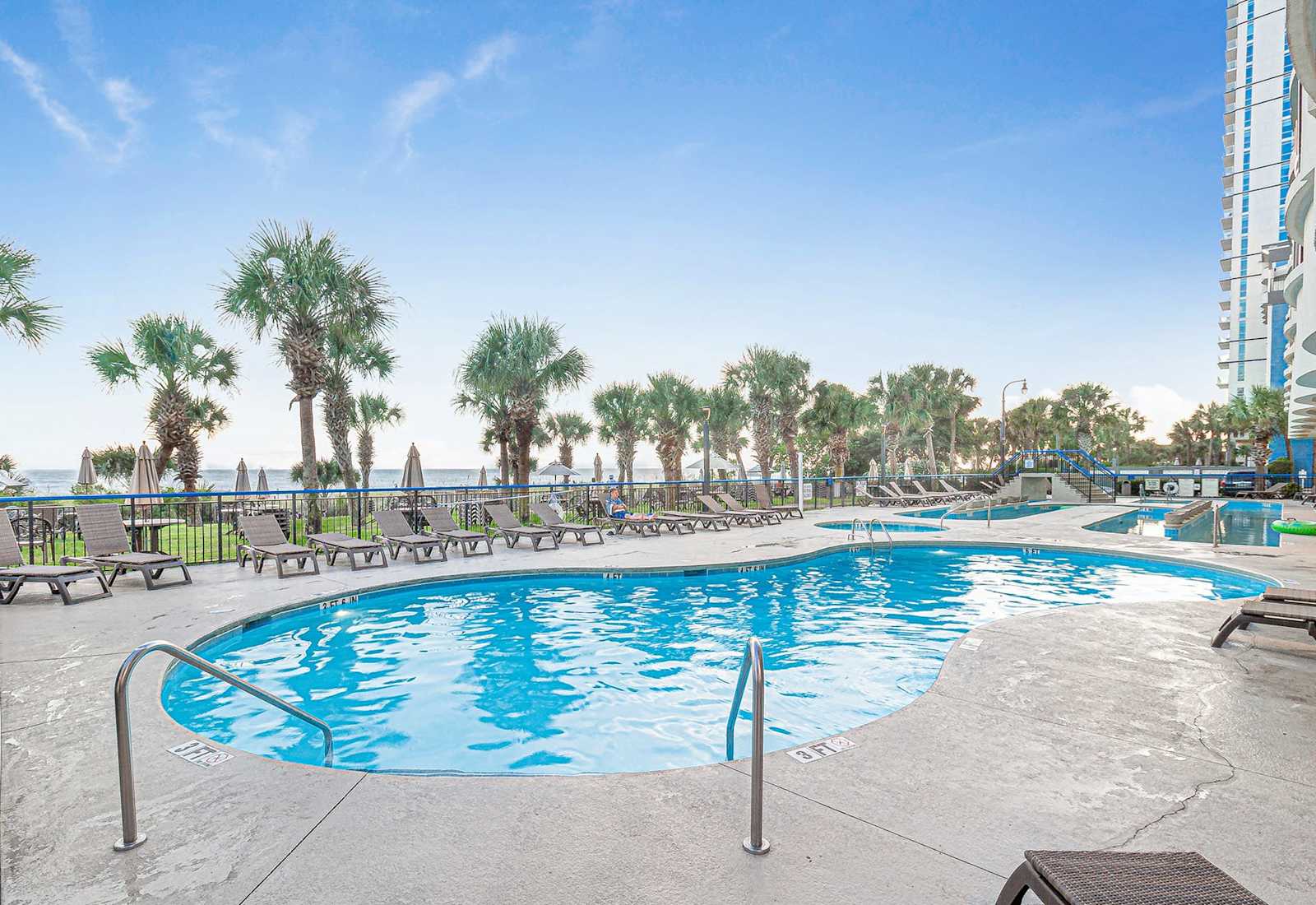 Unwind by the oceanfront pool with palm-lined views and sunny skies at your fingertips. This Myrtle Beach gem offers the perfect spot to lounge, splash, and soak in the ultimate coastal getaway experience.