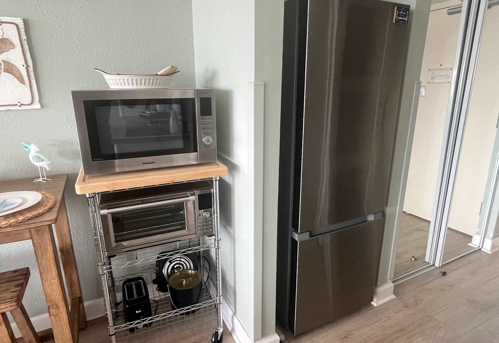 Full size stainless steel refrigerator paired with a convenient microwave and toaster oven station