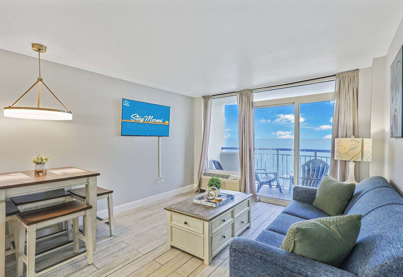 Relax in this bright and airy oceanfront living space featuring cozy seating, a dining nook, and stunning balcony views. The perfect Myrtle Beach retreat for dining, lounging, and soaking up those coastal vibes!