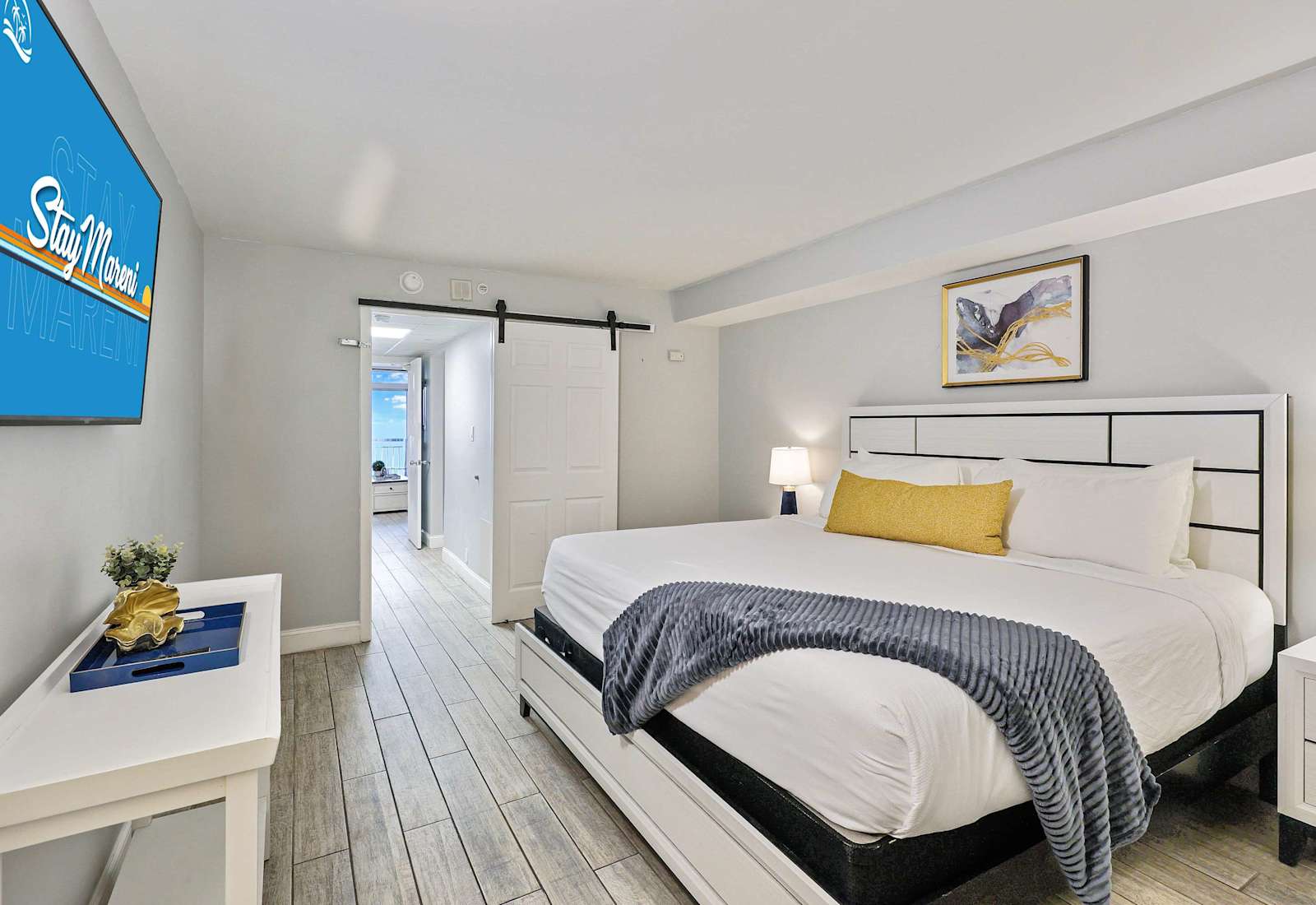 Drift into comfort in this stylish bedroom featuring a plush king bed, smart TV, and modern coastal decor. The perfect place to relax after a day of sun and sand during your unforgettable Myrtle Beach escape!