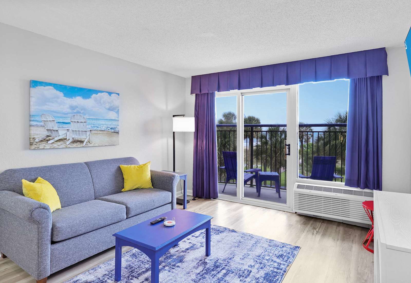 Wake up to palm trees and ocean views in this vibrant, coastal-chic living room. Slide open the doors, sip your morning coffee on the balcony, and let the sea breeze set the mood. 