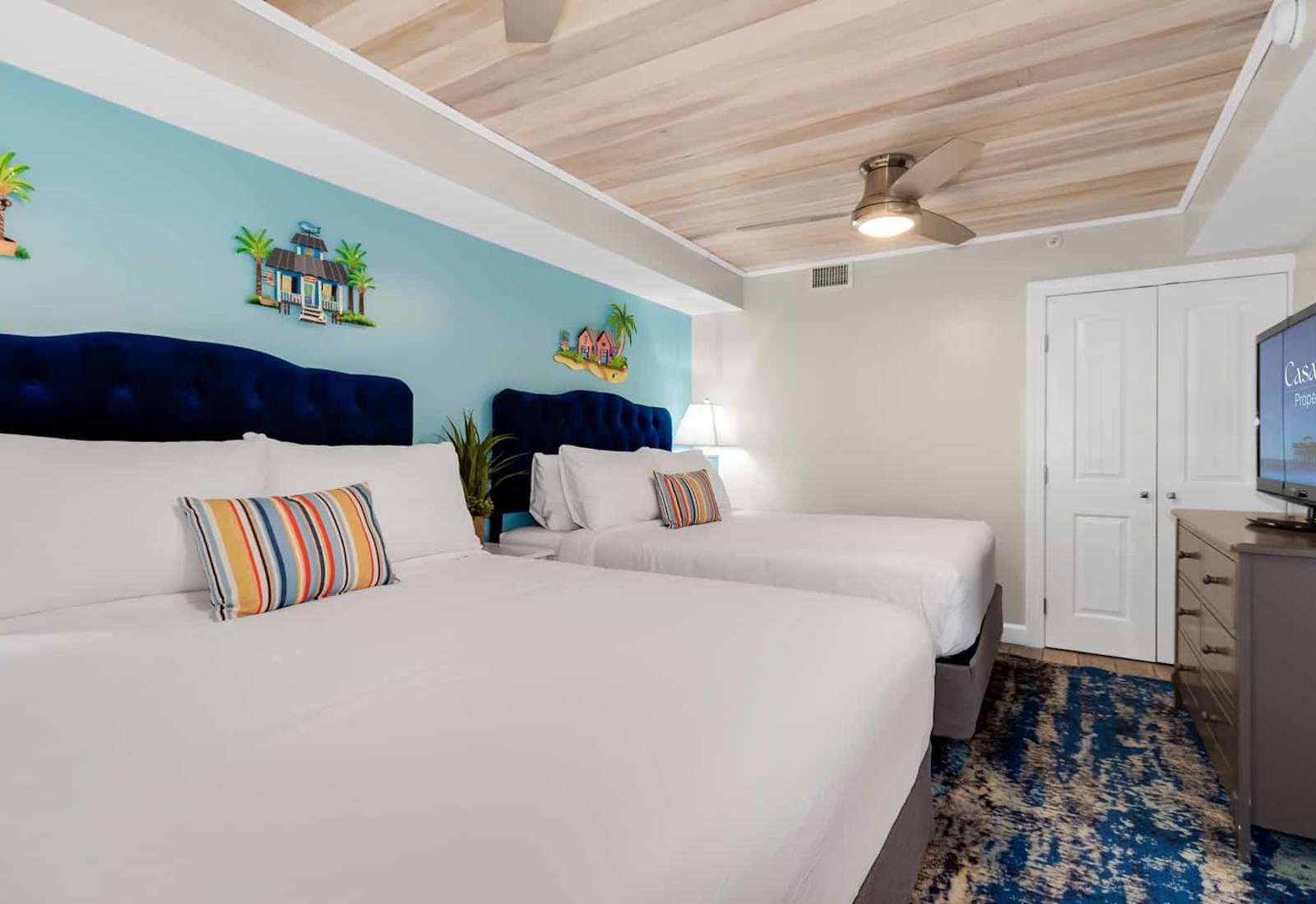 Relax in style in this serene bedroom featuring a plush bed, soothing coastal decor, and ample natural light. Drift off to the sound of the waves and wake up refreshed, just steps away from breathtaking ocean views. 