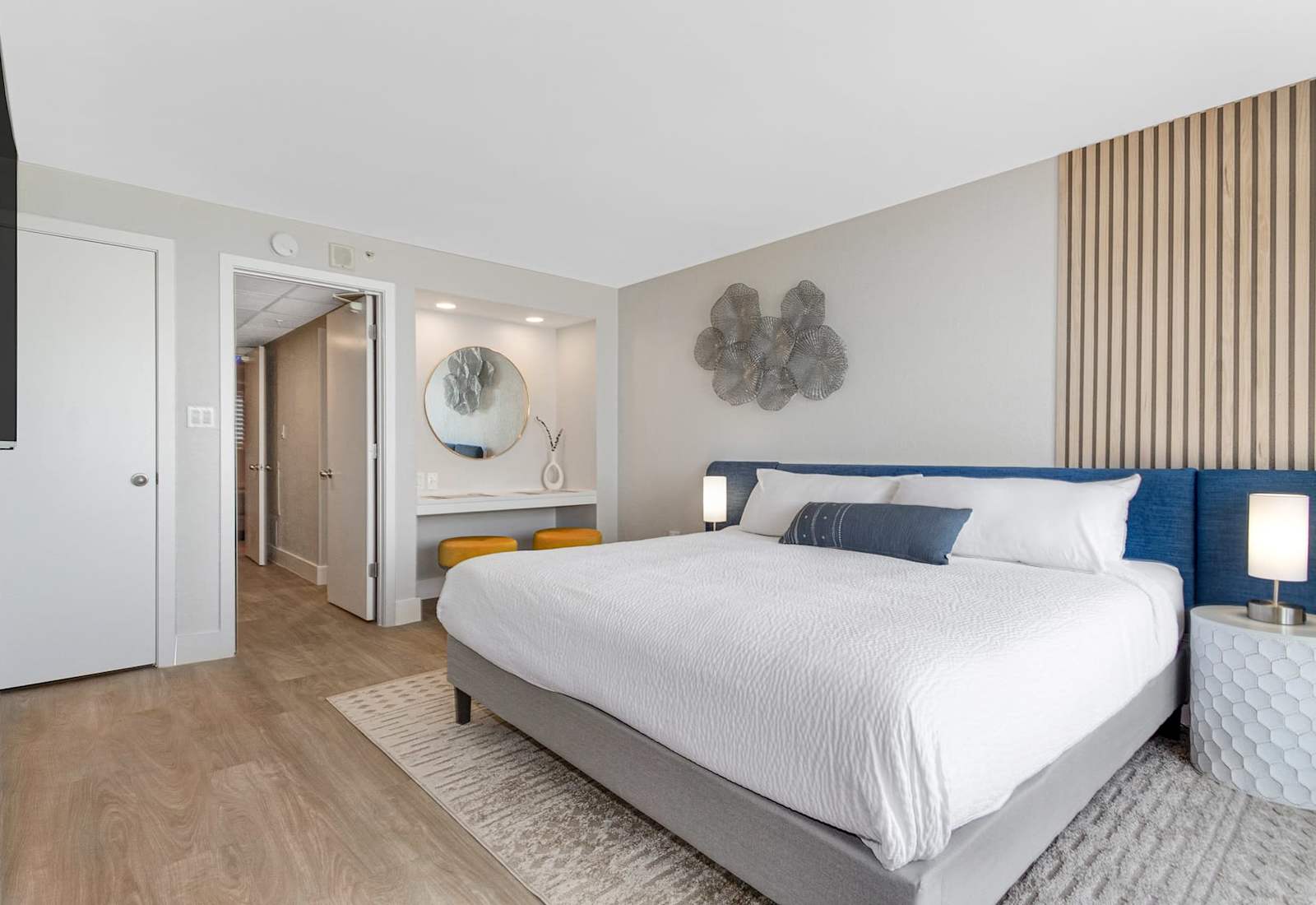 Retreat to this elegant bedroom featuring a luxurious king bed, chic decor, and a cozy vanity nook. Thoughtfully designed with modern accents and soft lighting, this space offers a perfect blend of style and comfort for a restful night’s sleep.