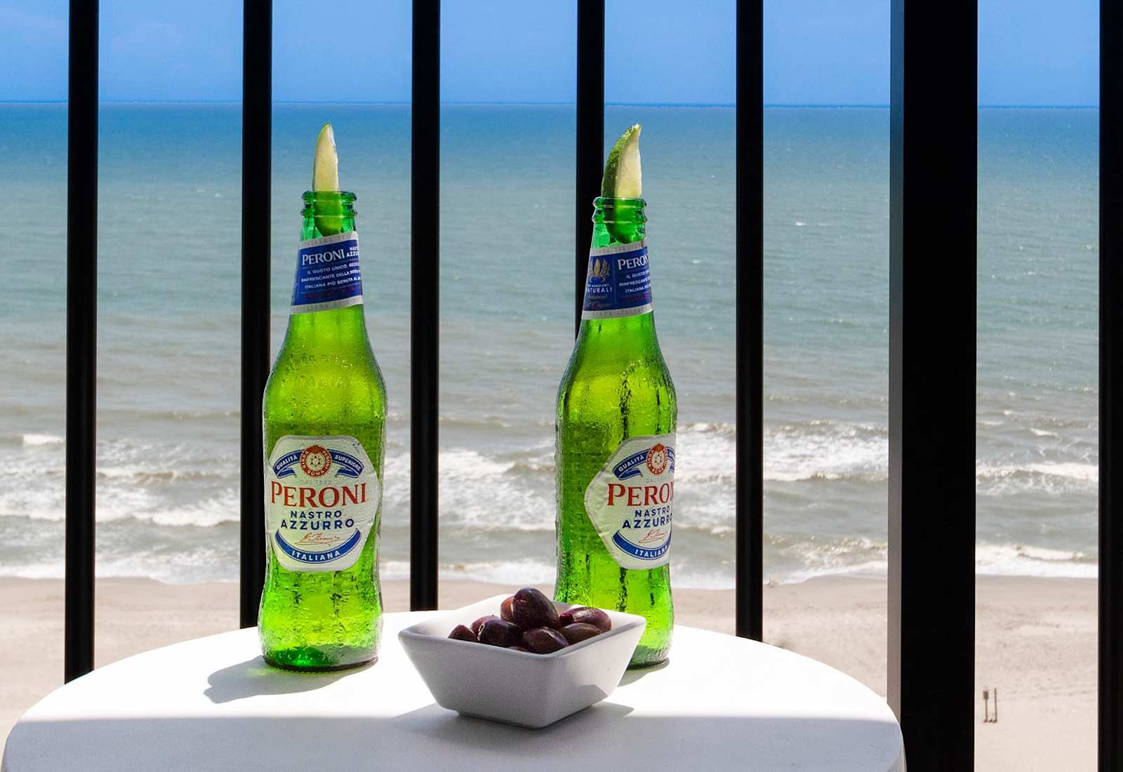 Enjoy a refreshing Peroni with a side of olives on your balcony, overlooking the waves. The perfect setting to unwind, sip, and savor the tranquil seaside ambiance, turning a simple moment into a memorable escape.
