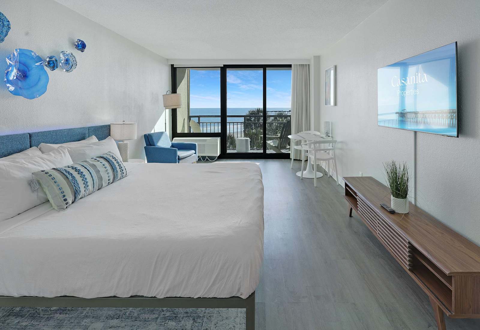 Wake up to beautiful ocean views in this airy coastal retreat, featuring a private balcony, comfortable sleeping area, and a simple dining space for an easy beach getaway.