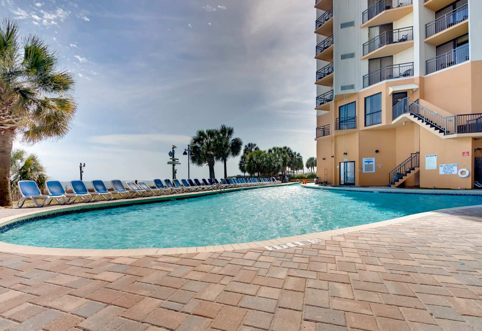 Unwind by the sparkling beachfront pool surrounded by palm trees and ocean views. Whether you're swimming laps or lounging with a book, this is your personal slice of paradise.