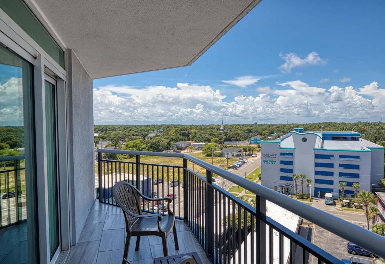 Step out onto your private balcony for fresh air and an open outdoor space, offering a peaceful overlook of the urban surroundings.