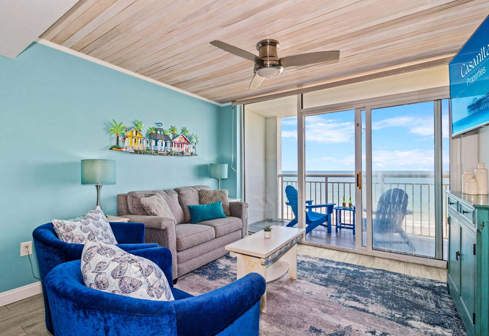 Step into this inviting living space with vibrant coastal decor, plush seating, and a private balcony showcasing breathtaking ocean views. Perfect for relaxing after a day at the beach, this room brings comfort and style to your seaside retreat.