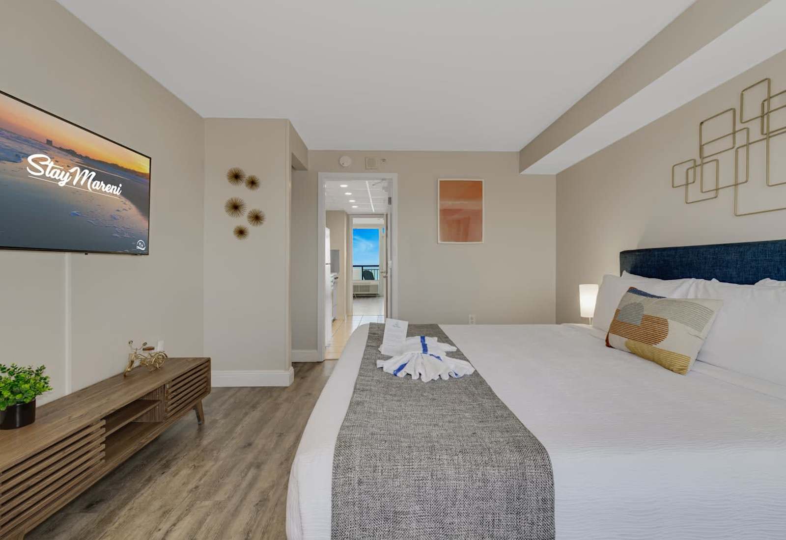 Relax in this serene coastal bedroom featuring plush beds, soft linens, and cheerful pops of color—perfect for unwinding after a day at the beach or waking up to gentle morning light.