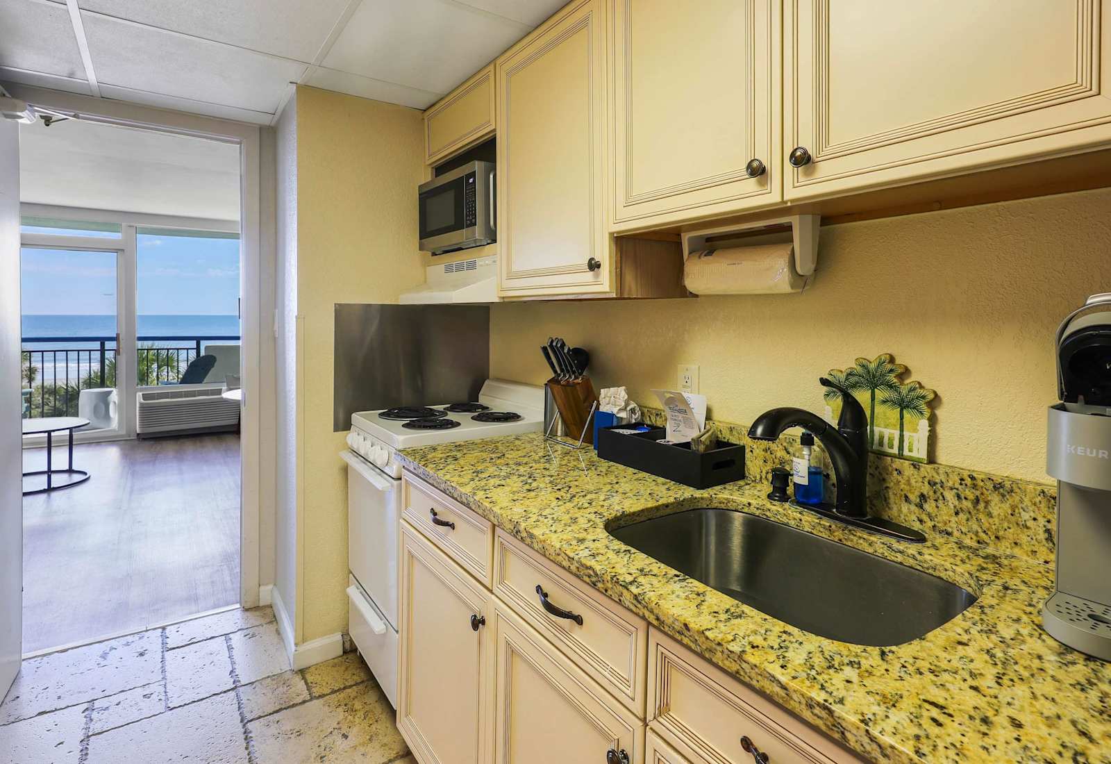 Bright, fully equipped kitchen with essential appliances and plenty of cabinet space for preparing meals during your stay.