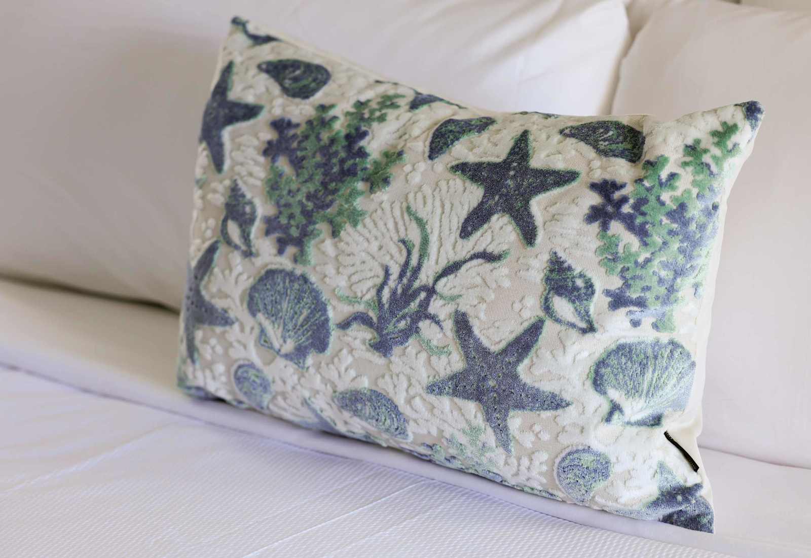 Coastal charm is in the details. Thoughtfully styled with ocean-inspired accents, every element of this space is designed to bring the relaxing vibes of the beach right to your bedside.