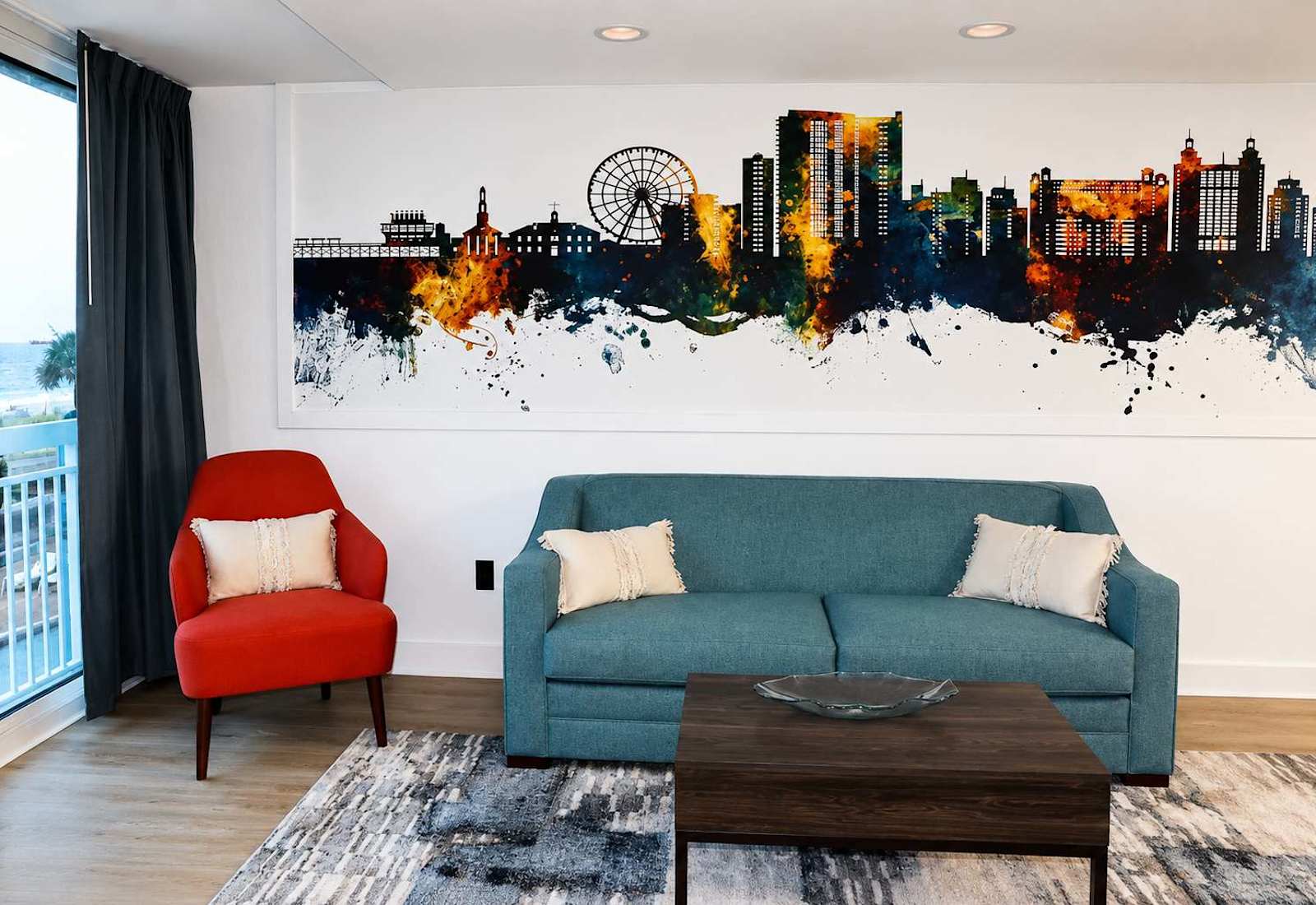 Relax on the plush teal sofa right beneath our striking watercolor skyline mural!