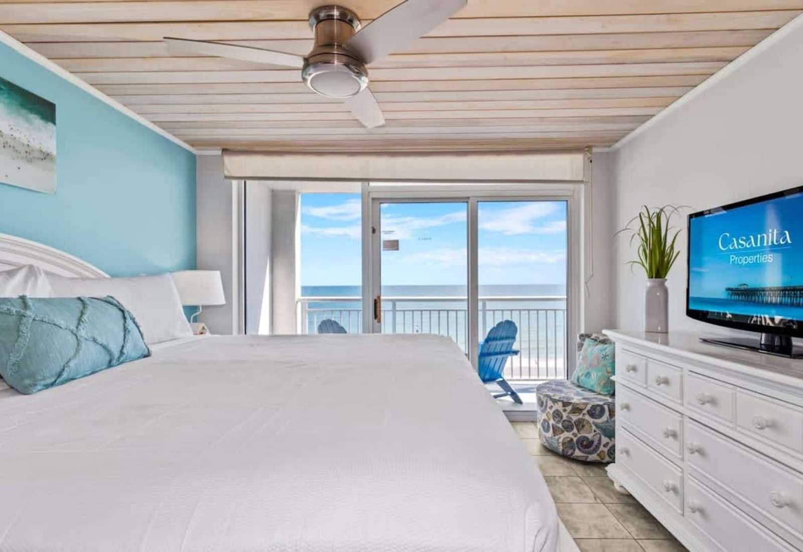 Retreat to this serene bedroom featuring a plush king bed, stylish decor, and a flat-screen TV for entertainment. Wake up to natural light and glimpses of the ocean, creating a perfect blend of comfort and coastal charm.
