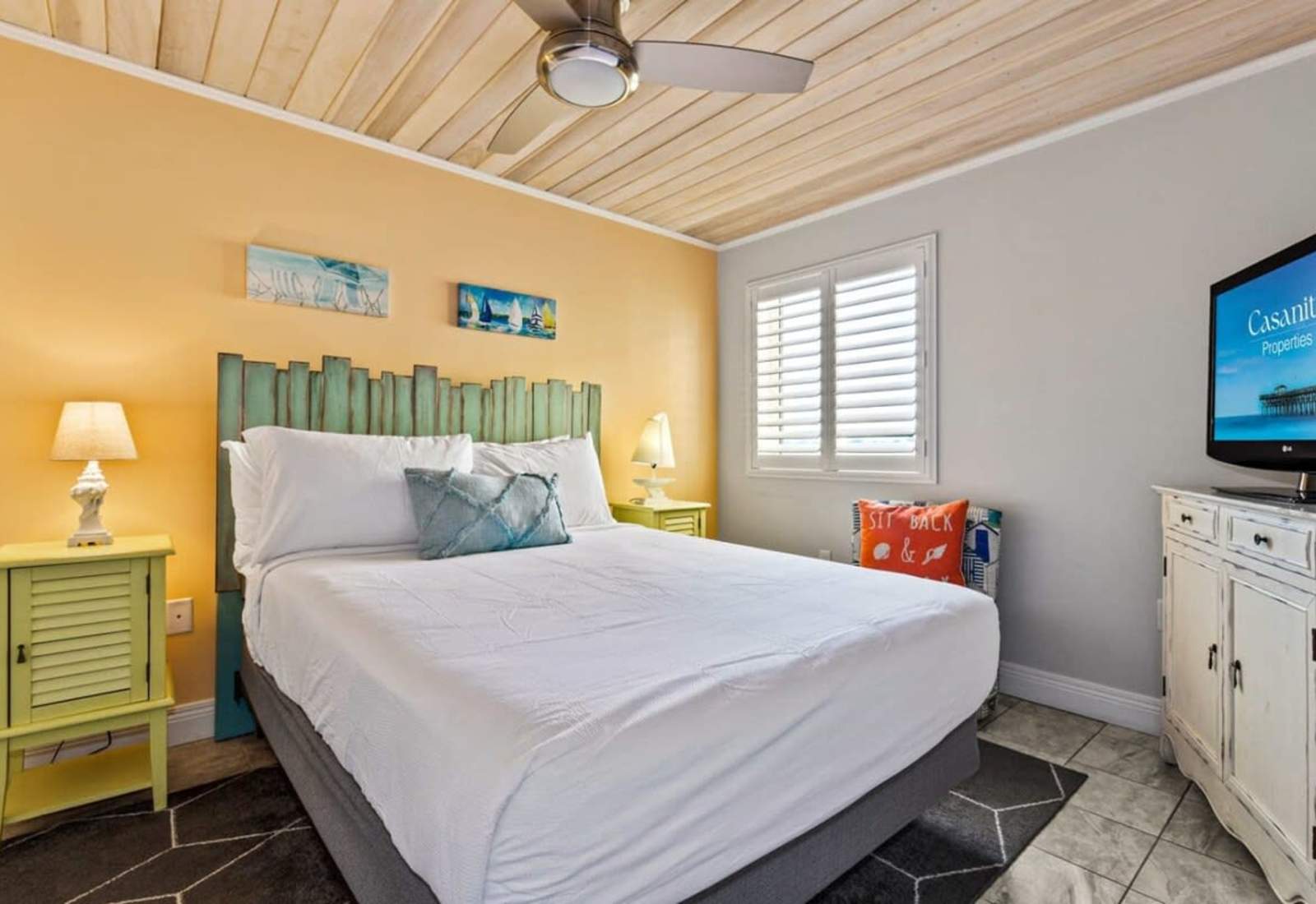 Retreat to this serene bedroom featuring a plush king bed, stylish decor, and a flat-screen TV for entertainment.