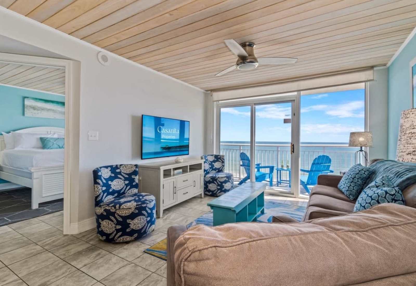 Relax in this bright and cozy living room featuring ocean-inspired decor, comfortable seating, and stunning balcony views. Perfect for unwinding after a day at the beach, this space invites you to soak in the coastal vibes in style.