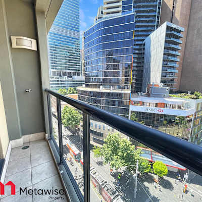 Balcony view overlooking the city streets and light rail below.